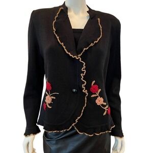 Gia on a black knit sweater with embroidery SZ. M